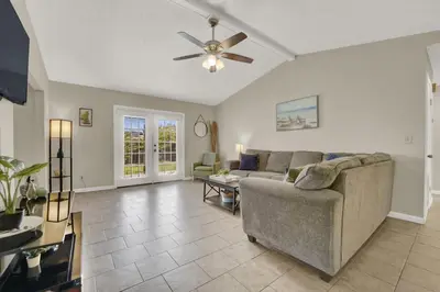 a living room with a couch and a ceiling fan at Two Spaces in One Main House and Guest House 25 Min to PCB in Panama City