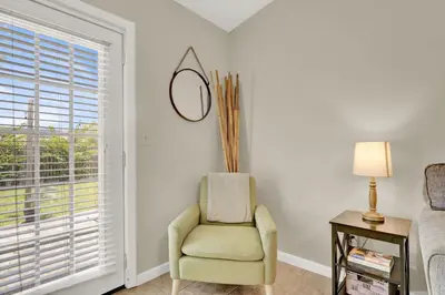 a living room with a chair and a window at Two Spaces in One Main House and Guest House 25 Min to PCB in Panama City