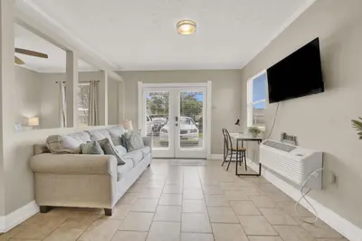 a living room with a couch and a television at Two Spaces in One Main House and Guest House 25 Min to PCB in Panama City