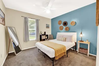 a bedroom with a large bed and a window at Two Spaces in One Main House and Guest House 25 Min to PCB in Panama City