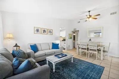 a living room with a couch and a table at Horizon South 23A by InJoy Vacations in Panama City Beach