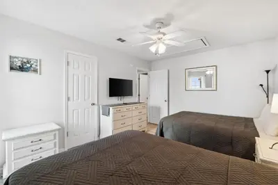 a bedroom with two beds and a ceiling fan at Horizon South 23A by InJoy Vacations in Panama City Beach