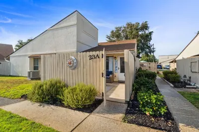 a small house with a gambrel roof at Horizon South 23A by InJoy Vacations in Panama City Beach