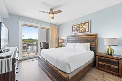 a bedroom with a bed and a balcony at Laketown Wharf Resort #238 by Book That Condo in Panama City Beach