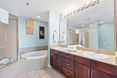 a bathroom with two sinks and a tub and a shower at Laketown Wharf Resort #238 by Book That Condo in Panama City Beach