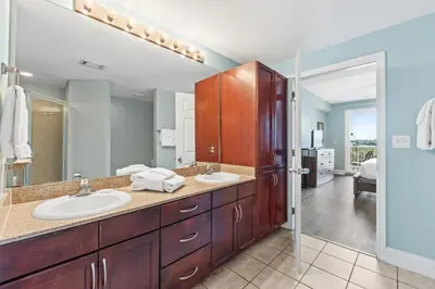 a bathroom with two sinks and a large mirror at Laketown Wharf Resort #238 by Book That Condo in Panama City Beach