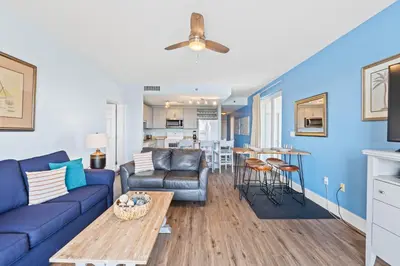 a living room with a couch and a table at Laketown Wharf Resort #238 by Book That Condo in Panama City Beach