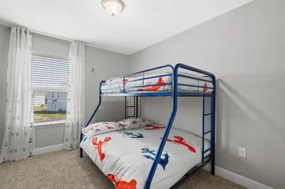 a bedroom with a bunk bed and a window at NEW ⁂Serenity Beach⁂ Lakefront 3BRs Close to Beach in Panama City Beach