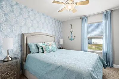 a bedroom with a bed and a ceiling fan at NEW ⁂Serenity Beach⁂ Lakefront 3BRs Close to Beach in Panama City Beach