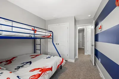 a bedroom with a bunk bed and a blue and white wall at NEW ⁂Serenity Beach⁂ Lakefront 3BRs Close to Beach in Panama City Beach