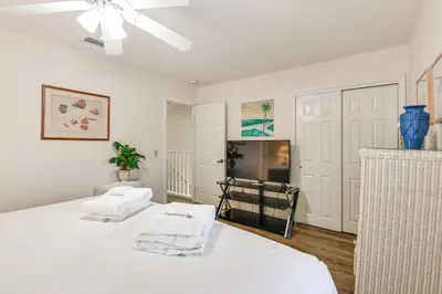 a bedroom with two beds and a ceiling fan at PCB Townhome with Resort Amenities - Walk to Ocean! in Panama City Beach