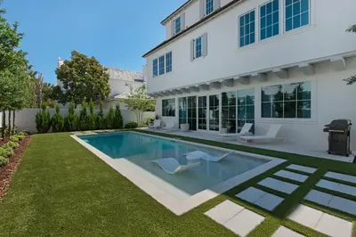 a swimming pool in the yard of a house at Verisun - 40 Elysee Court home in Inlet Beach