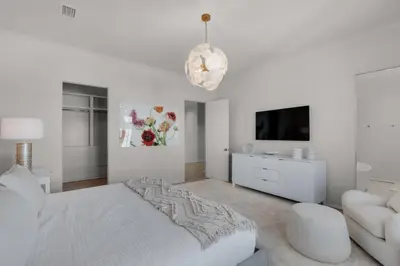 a white bedroom with a bed and a couch at Verisun - 40 Elysee Court home in Inlet Beach
