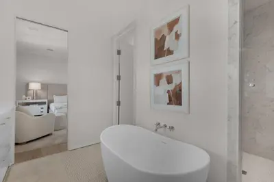a white bathroom with a white toilet in a room at Verisun - 40 Elysee Court home in Inlet Beach
