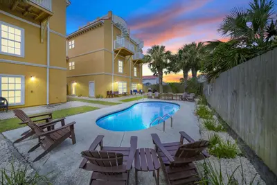a house with a swimming pool and some chairs at Summer Special, Lux 4BR House Sleeps 12, Pool, Elevator, King bed in Panama City Beach