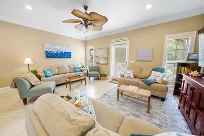 a living room with couches and chairs and a ceiling fan at Summer Special, Lux 4BR House Sleeps 12, Pool, Elevator, King bed in Panama City Beach