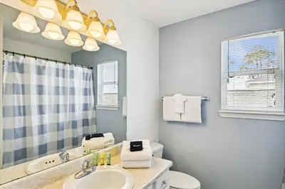 a bathroom with a sink and a toilet and a mirror at Babberville 11818 By Book That Condo in Panama City Beach