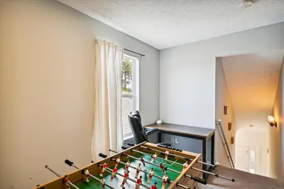 a ping pong table in a room with a desk at Babberville 11818 By Book That Condo in Panama City Beach