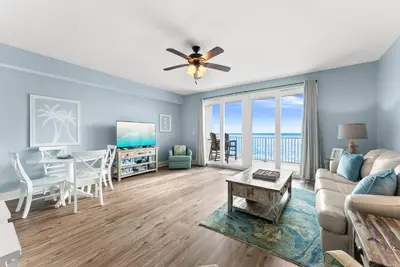 a living room with a couch and a table and a dining room at Remodeled Resort Condo! Ocean & Beach Views by Dolce Vita Getaways PCB in Panama City Beach