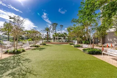 a park with benches and grass and trees at Remodeled Resort Condo! Ocean & Beach Views by Dolce Vita Getaways PCB in Panama City Beach