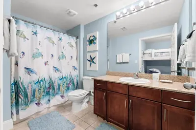 a bathroom with a toilet and a shower curtain at Remodeled Resort Condo! Ocean & Beach Views by Dolce Vita Getaways PCB in Panama City Beach