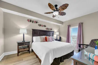 a bedroom with a bed and a ceiling fan at Stunning Ocean & Sunset Views, Direct Beach Access with 2 King Bedrooms at Panama City Beach, Fl in Panama City Beach