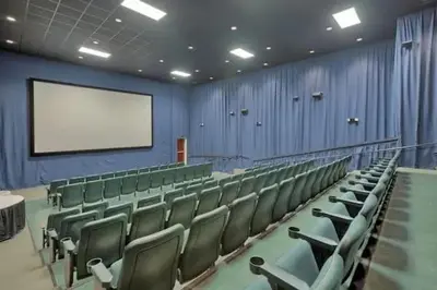 a lecture hall with green chairs and a white screen at Stunning Ocean & Sunset Views, Direct Beach Access with 2 King Bedrooms at Panama City Beach, Fl in Panama City Beach