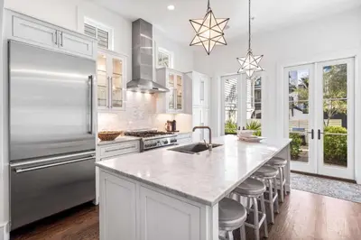 a kitchen with a stainless steel refrigerator and a counter at Found My Zen in Rosemary Beach