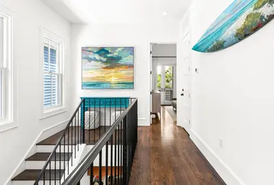 a staircase in a home with a painting on the wall at Found My Zen in Rosemary Beach
