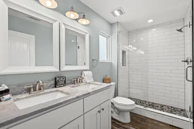 a bathroom with a sink and a toilet at Coral Cabana - 3BD 2BA Home Close to Beach w/ optional Golf Cart! in Panama City Beach