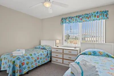 a bedroom with two beds and a window at 2BD/25BA Gulf Front Townhome near Pier Park! Gulf Views! Beach Access! in Panama City Beach