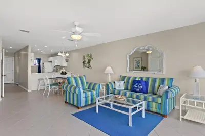 a living room with two chairs and a table at 2BD/25BA Gulf Front Townhome near Pier Park! Gulf Views! Beach Access! in Panama City Beach