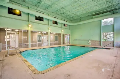 a large swimming pool with blue water in a building at Panama City Beach Condo Balcony with Ocean Views! in Panama City Beach