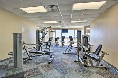 a gym with several treadmills and cardio machines at Panama City Beach Condo Balcony with Ocean Views! in Panama City Beach
