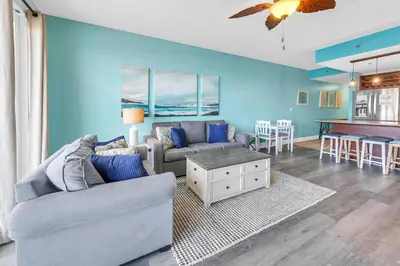 a living room with a couch and a table at Laketown Wharf 607 in Panama City Beach