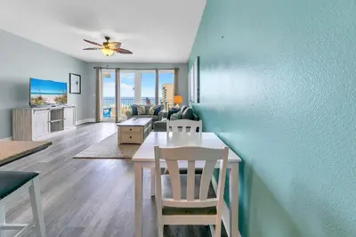 a dining room and living room with a table and chairs at Laketown Wharf 607 in Panama City Beach