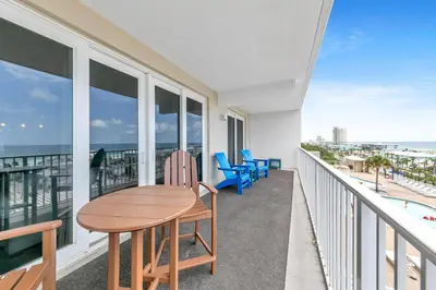 a balcony with a table and chairs and the ocean at Laketown Wharf 607 in Panama City Beach