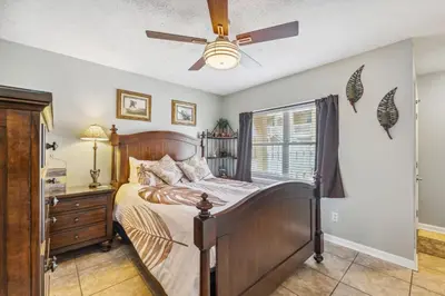 a bedroom with a bed and a ceiling fan at Merrimac Resort #31 in Panama City Beach