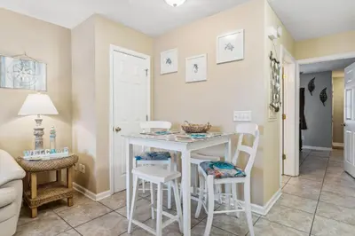 a kitchen with a table and chairs in a room at Merrimac Resort #31 in Panama City Beach