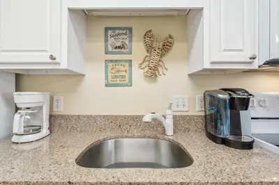a kitchen counter with a sink in a kitchen at Merrimac Resort #31 in Panama City Beach
