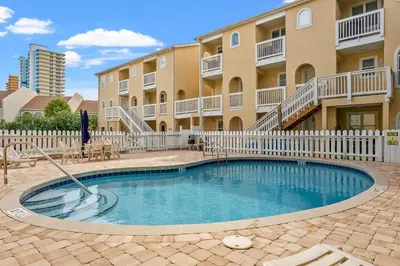a swimming pool in front of a apartment building at Merrimac Resort #31 in Panama City Beach