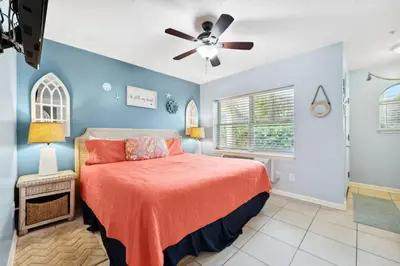 a bedroom with a bed and a ceiling fan at Merrimac Resort #41 in Panama City Beach