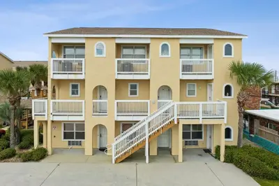 a large yellow building with white balconies at Merrimac Resort #41 in Panama City Beach