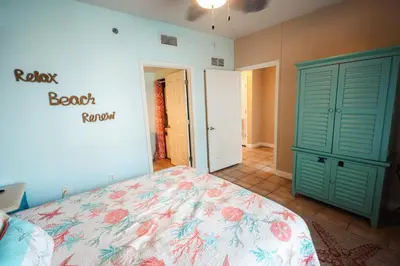 a bedroom with a bed and a green cabinet at Updated Beach Condo at the Shores of Panama Condos - Unit 918 in Panama City Beach