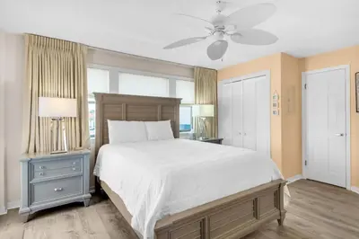 a bedroom with a large bed and a ceiling fan at St Thomas Square Villa 1211C Beach Bumz in Panama City Beach