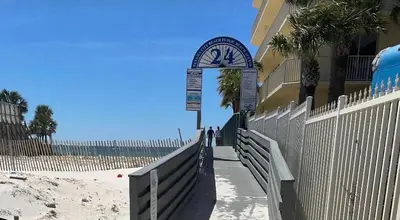 a clock on the side of a building next to the beach at St Thomas Square Villa 1211C Beach Bumz in Panama City Beach