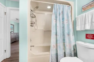 a bathroom with a shower and a toilet at St Thomas Square Villa 1211C Beach Bumz in Panama City Beach