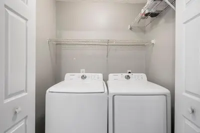 a laundry room with a washer and dryer at Barefoot Bungalow in Panama City Beach