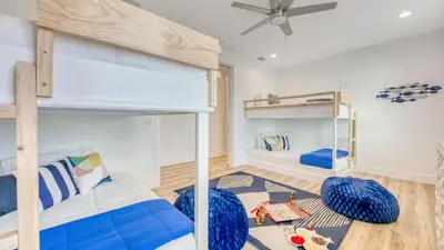 a bedroom with two bunk beds and a ceiling at Joyful Sound by AvantStay Walk to the Beach in Panama City Beach