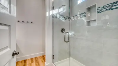 a shower with a glass door in a bathroom at Joyful Sound by AvantStay Walk to the Beach in Panama City Beach
